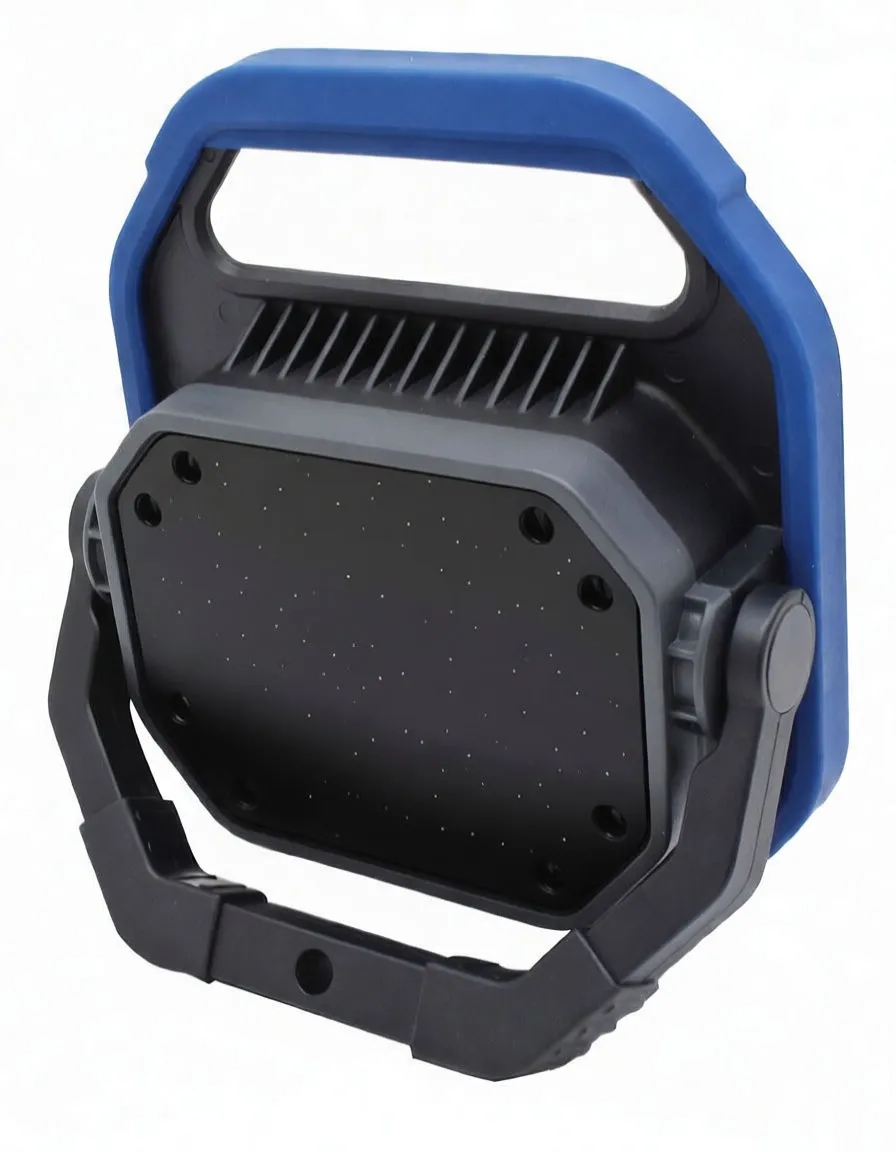 Hand holding the ASTA flood lamp by its integrated handle to show size and portability