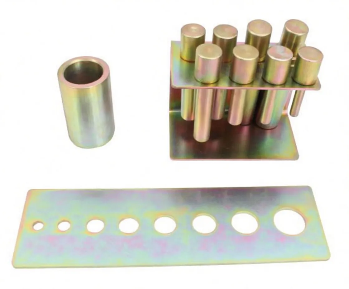 Overhead view of press pin adapter kit showing hole gauge plate with stamped sizes, sleeve and pin holder