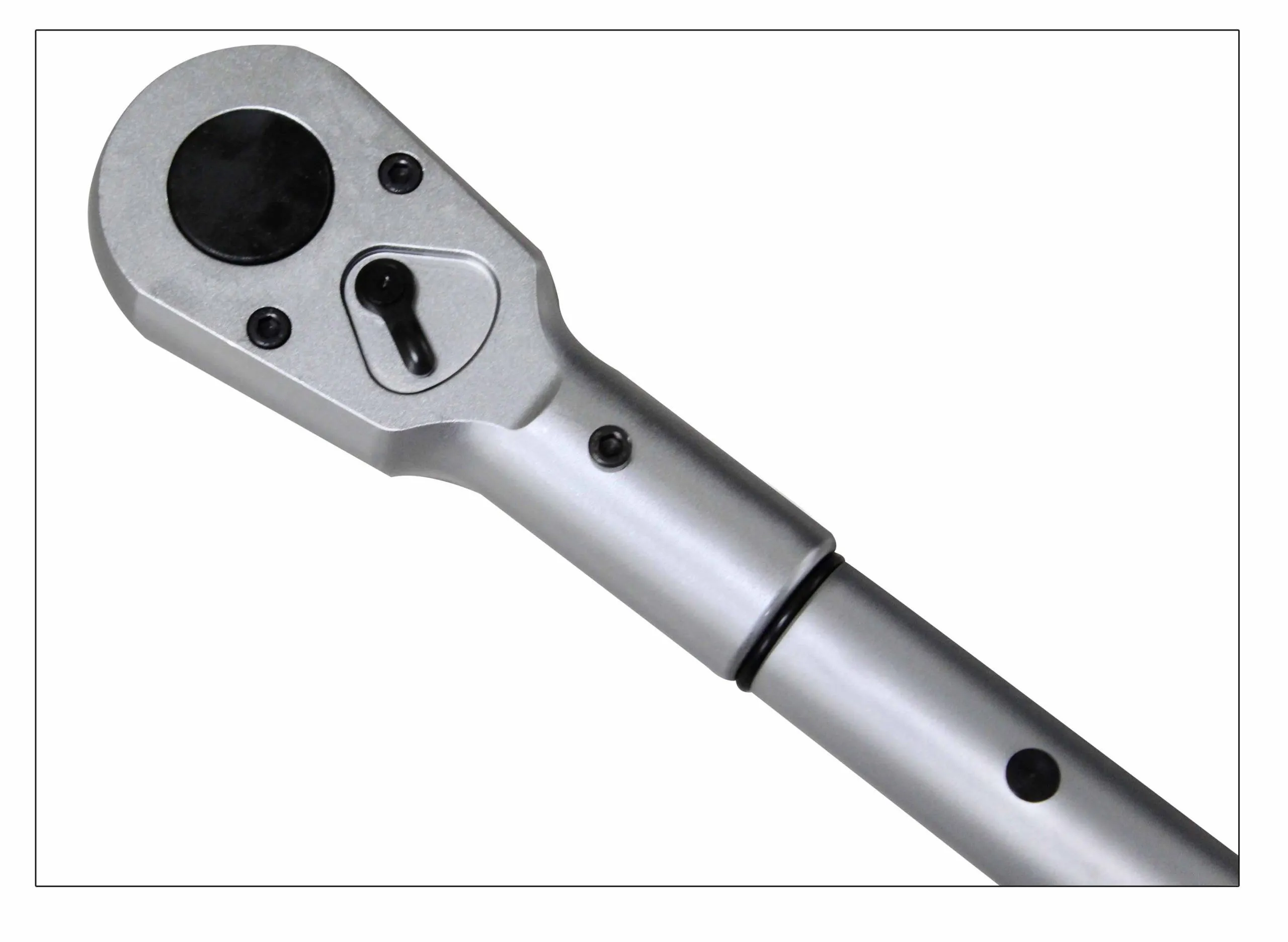 Close-up of torque wrench ratchet head showing black face cover, direction lever, screws and adjoining silver shaft.