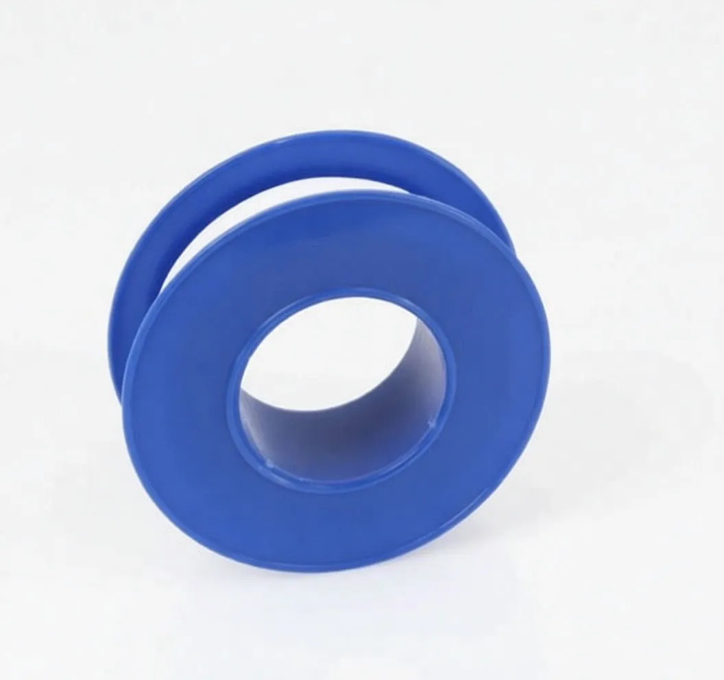 Angled spool of PTFE Teflon sealing tape, blue flanges with embossed ASTA and A-TT12M, small tape tail visible