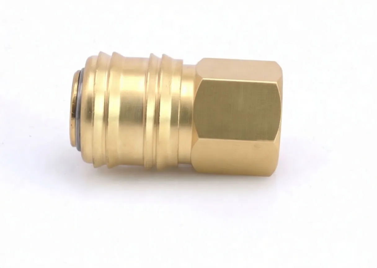 Three-quarter view of brass quick connector showing hexagonal female threads and coupling body