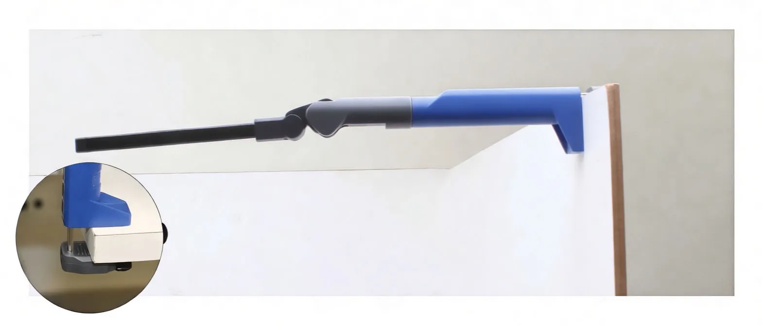 Gloved hand holding the foldable COB LED work light showing LED strip and button