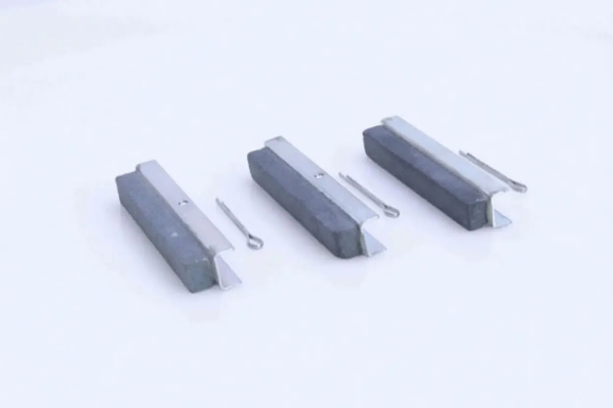 Three replaceable honing stones on metal brackets with three small retaining pins, shown on white background