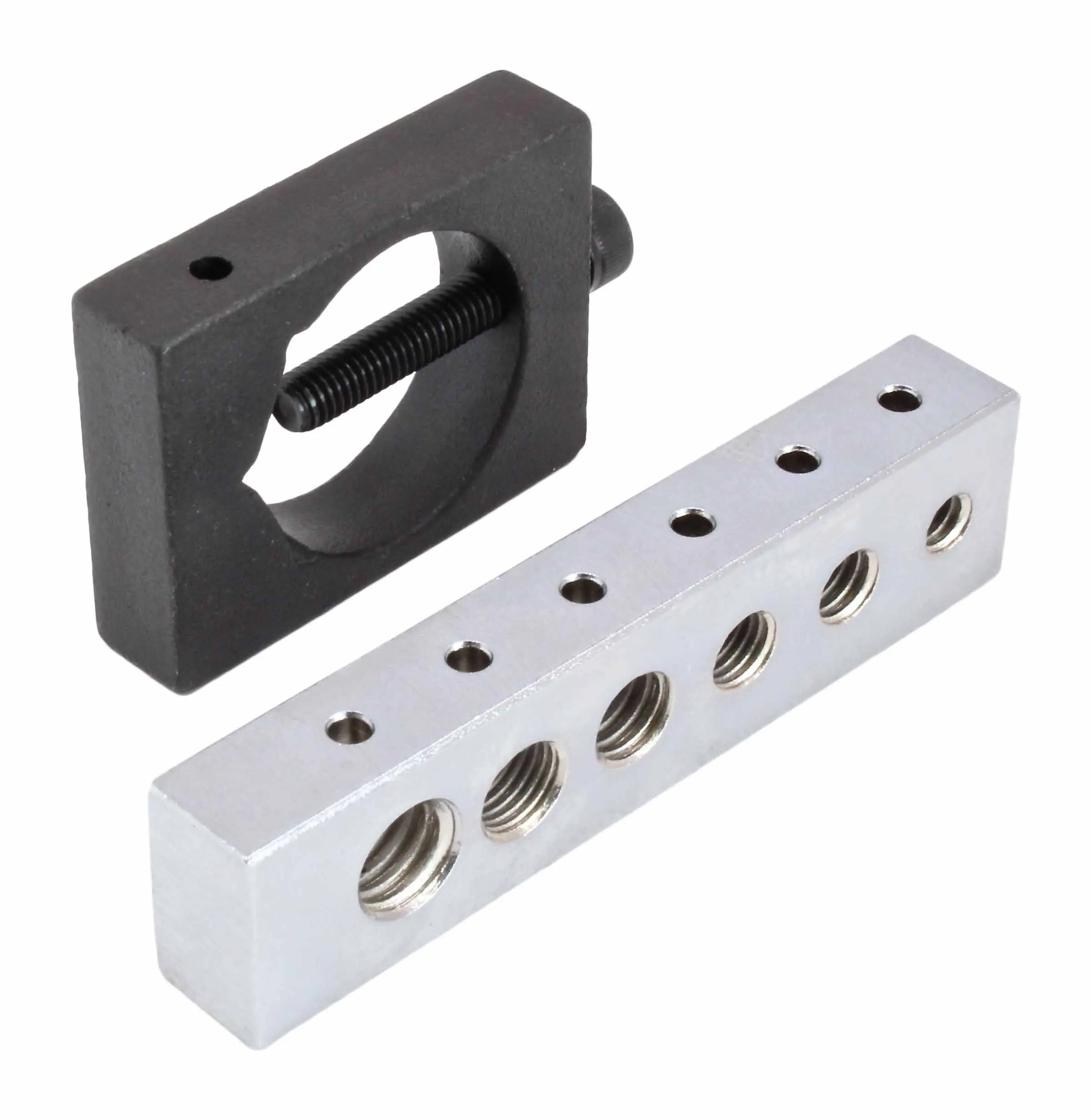 Angled view of black clamp with screw and silver machined block with multiple threaded bores