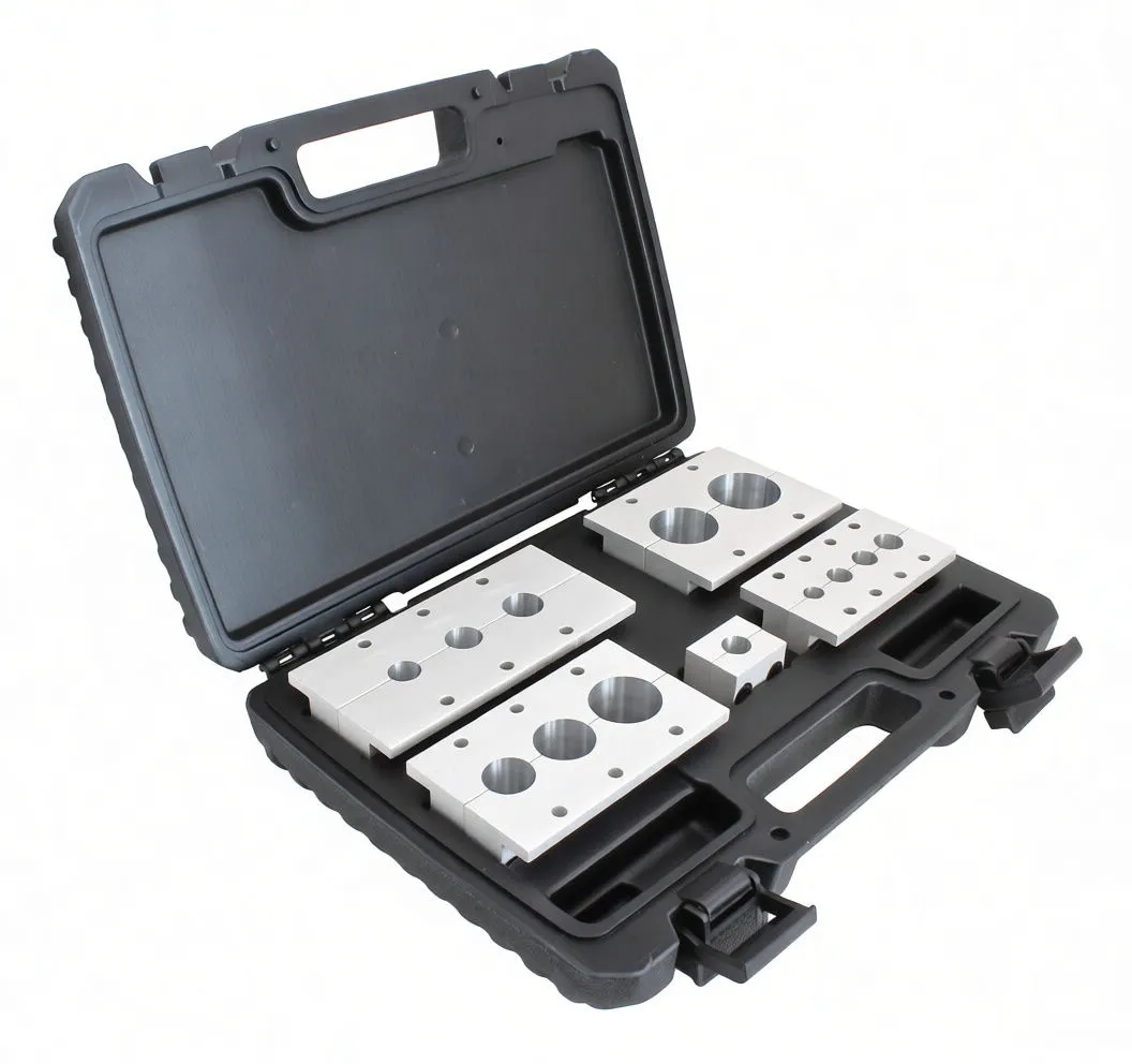Angled shot of open tool case showing multiple machined aluminum shaft-holding blocks and a packet of hardware