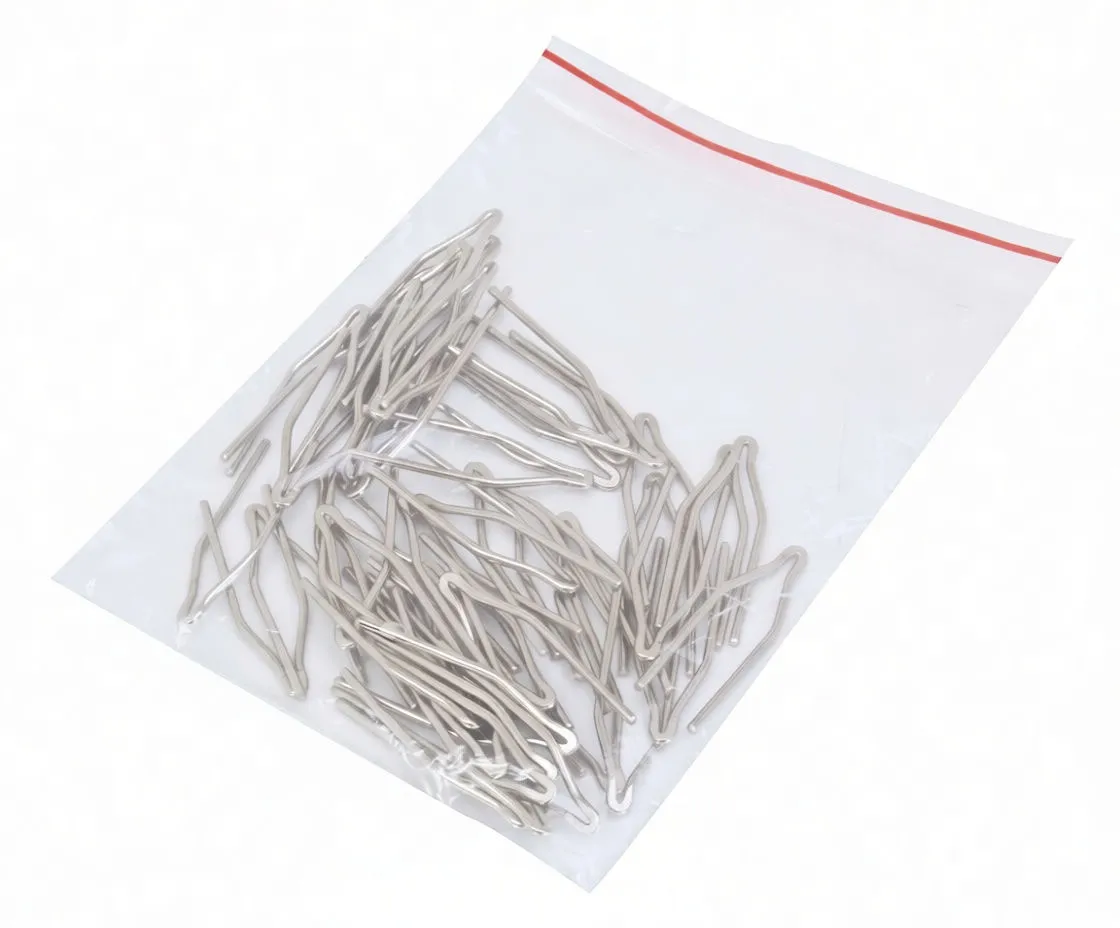 Transparent plastic bag of many polished U-shaped metal clips with a white 'satra' label and barcode