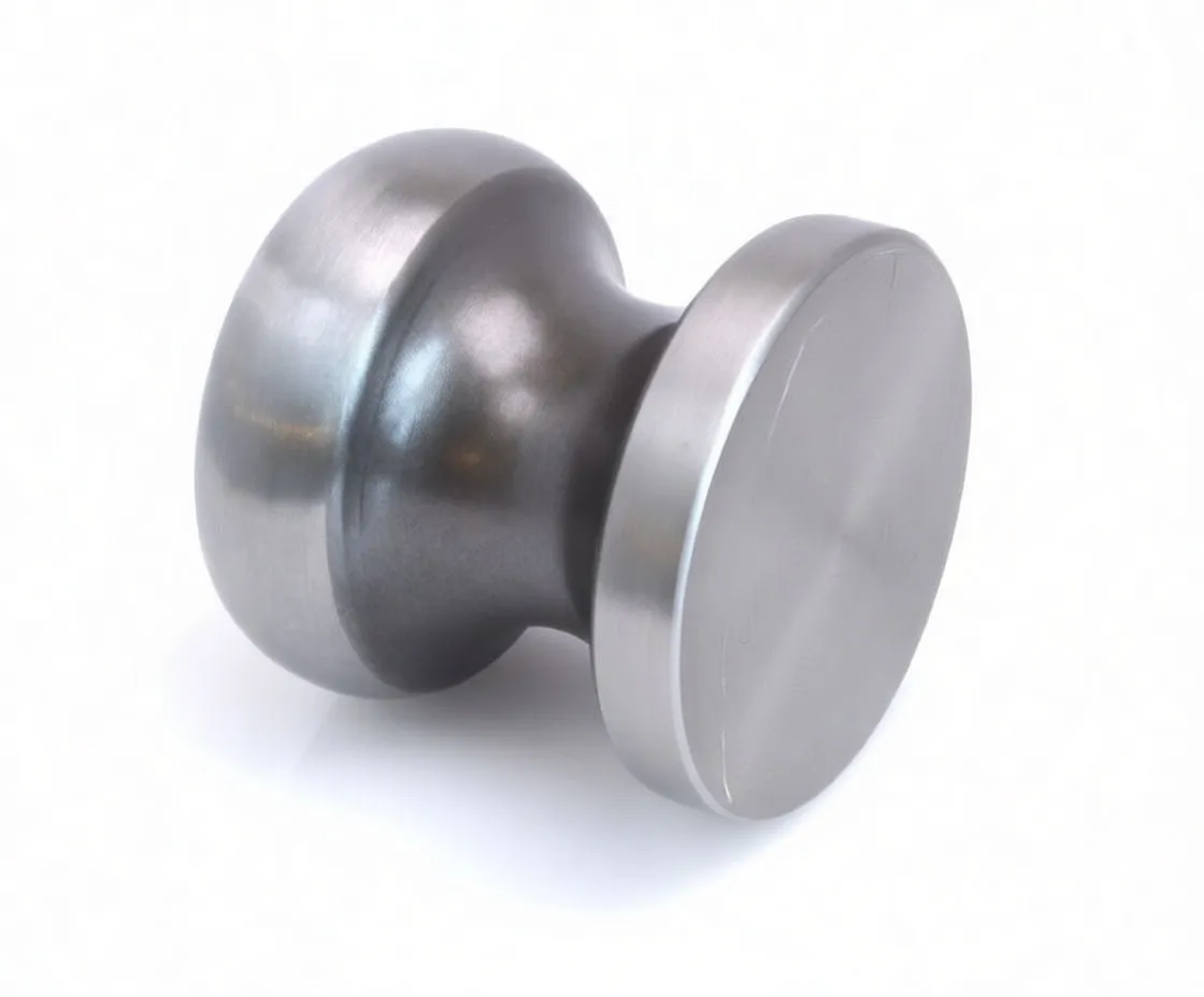 Reverse view of the metal knob with barcode sticker and a warning label about wearing safety goggles.