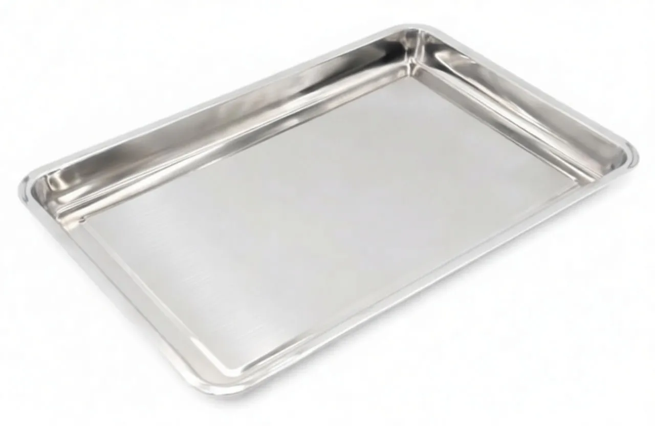 Angled view of stainless steel drain pan highlighting raised rim, rounded corners and 'saTra' brand marking on the base