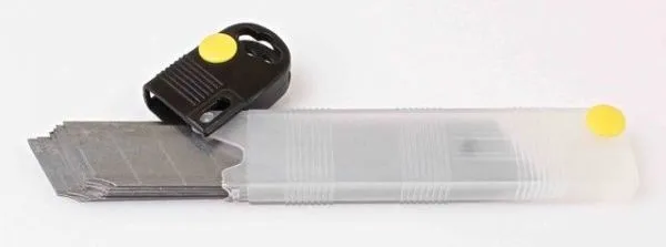 Open plastic blade dispenser with a stack of long snap-off blades and a black slider with yellow release button