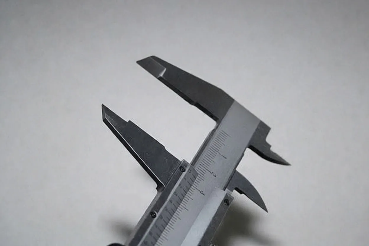 Close-up of caliper jaws, vernier scale and logo