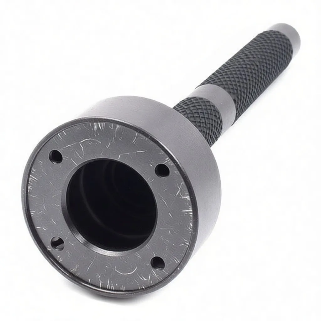 Close-up of steering rack knuckle tool head showing silver inner ring with engraved text and knurled shaft