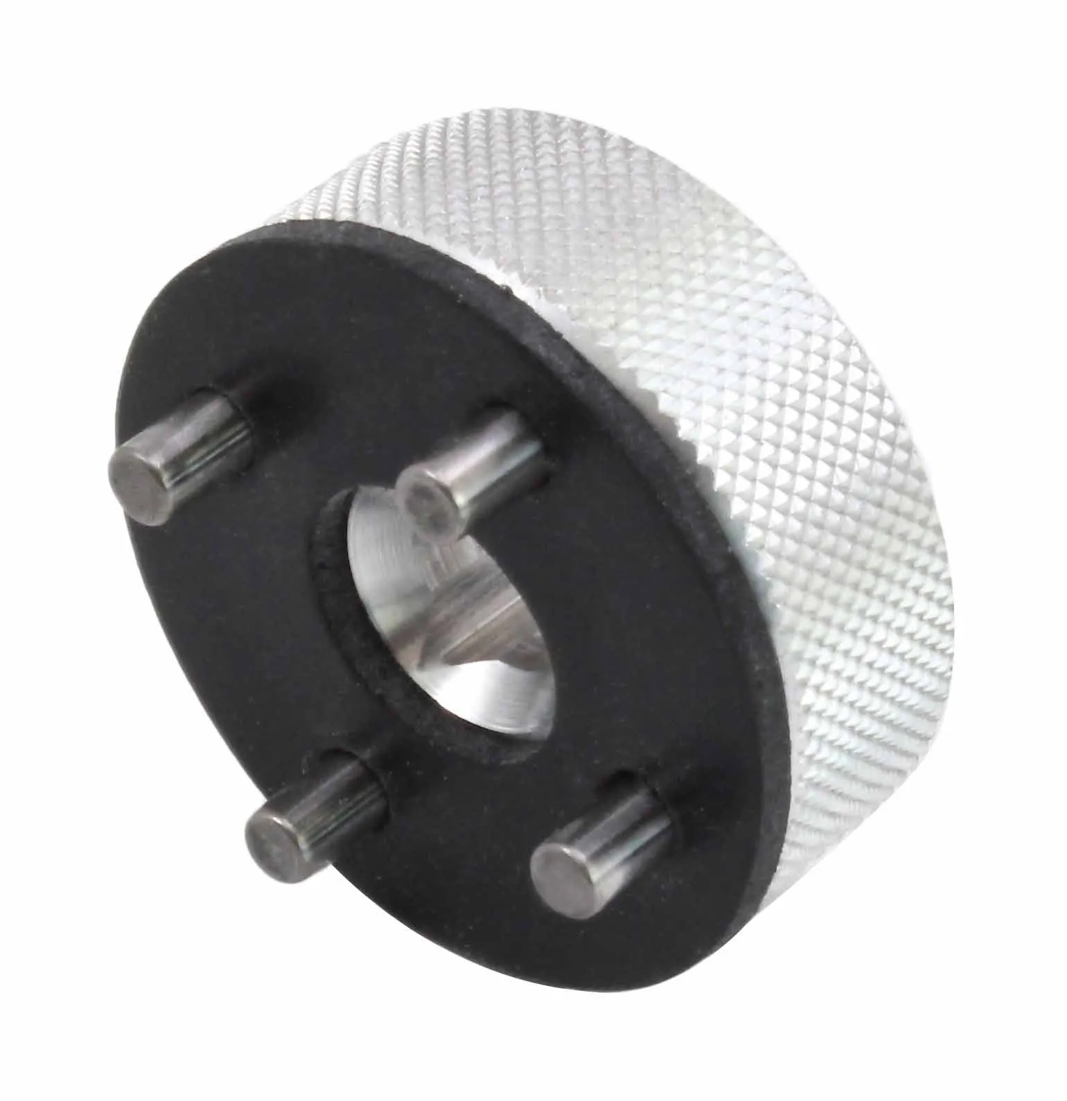 Angled view of steering stem nut tool highlighting three locating pins, knurled side and machined central bore