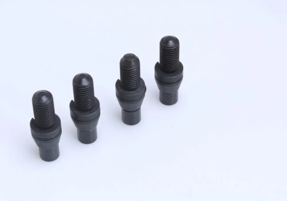 Four black threaded subframe locating bolts on a white background, showing threaded shanks and tapered locating ends.