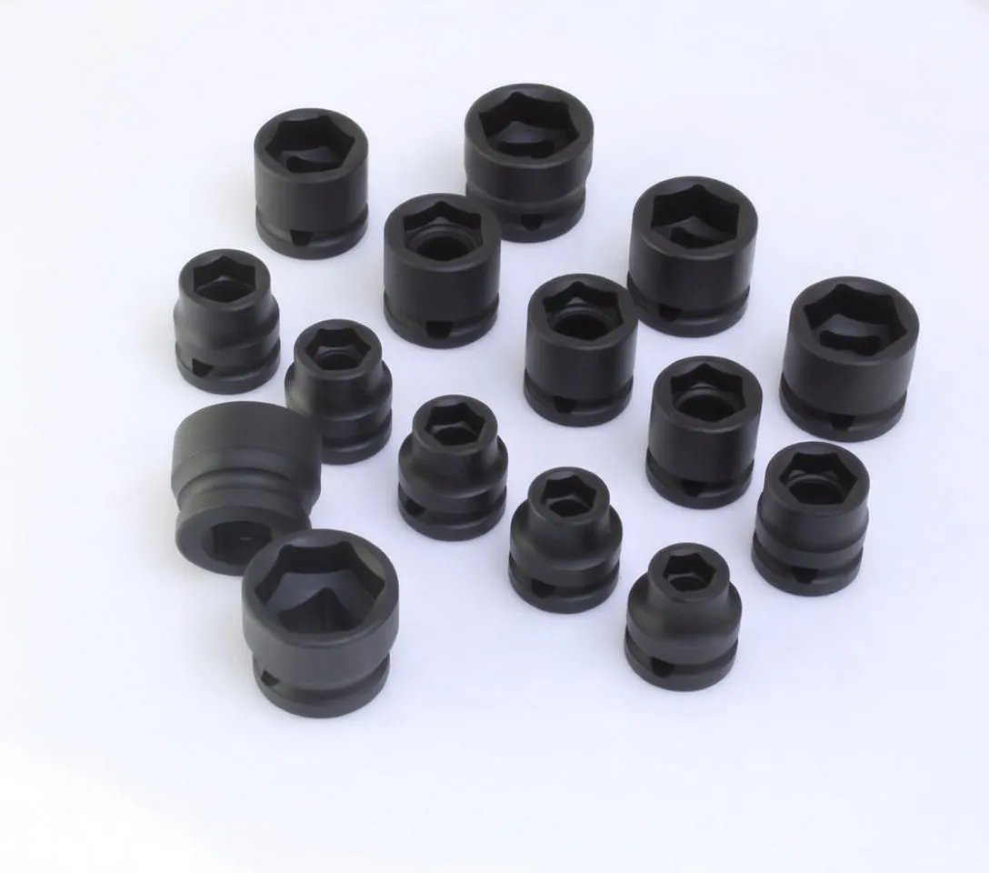 Scattered supershort black impact sockets on white background, close view of varying sizes including one marked ASTA CR-MO 23mm.