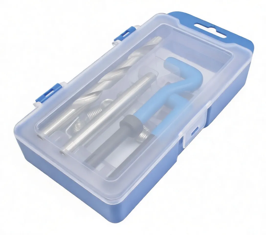 Drill, tap, two blue insertion tools, black drivers and a pile of stainless coil thread inserts on white background