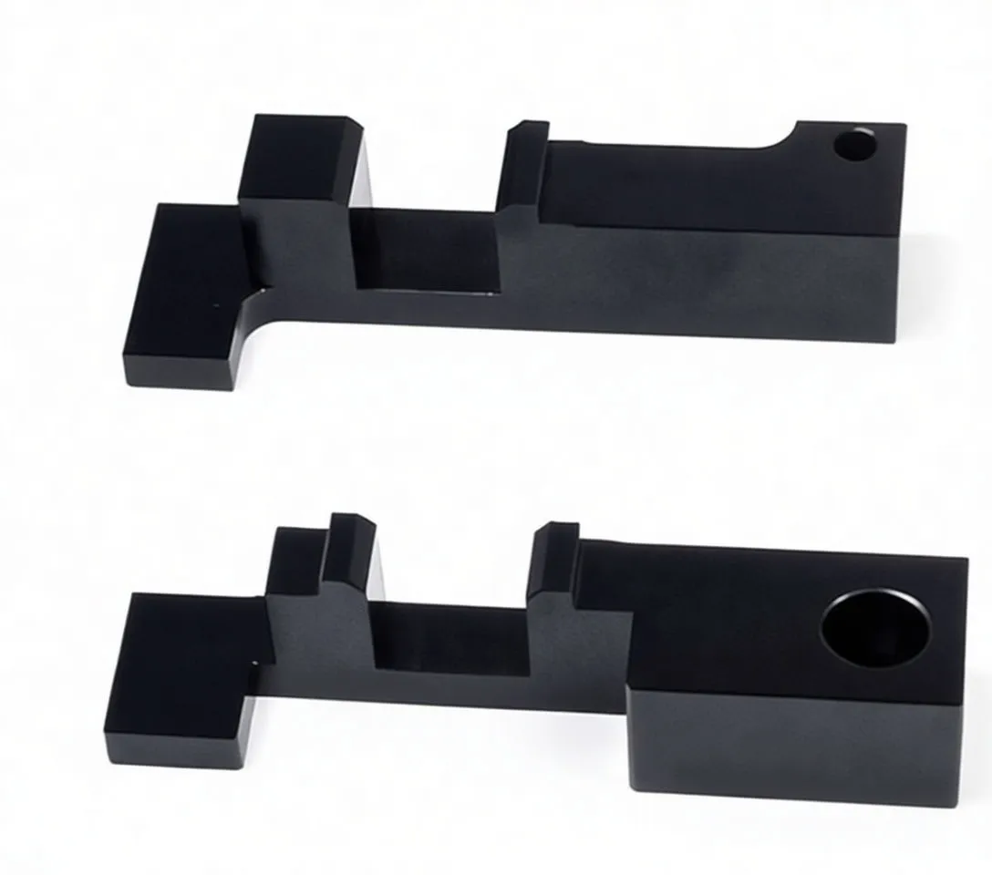 Two black machined timing locking blocks with ASTA logo and mounting holes on white background