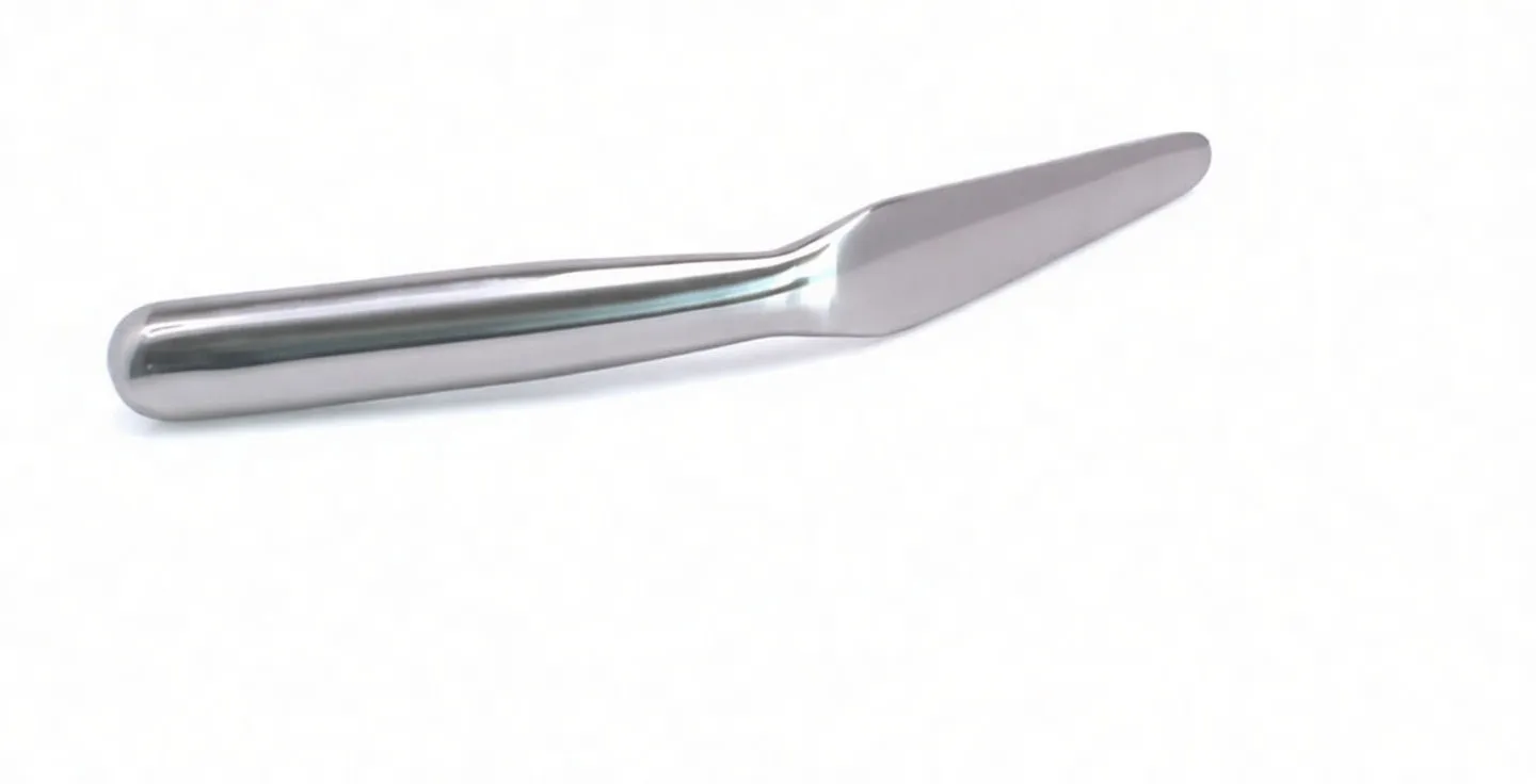 Tinsmith's spoon underside showing barcode and safety warning labels on the polished metal handle and shaft.