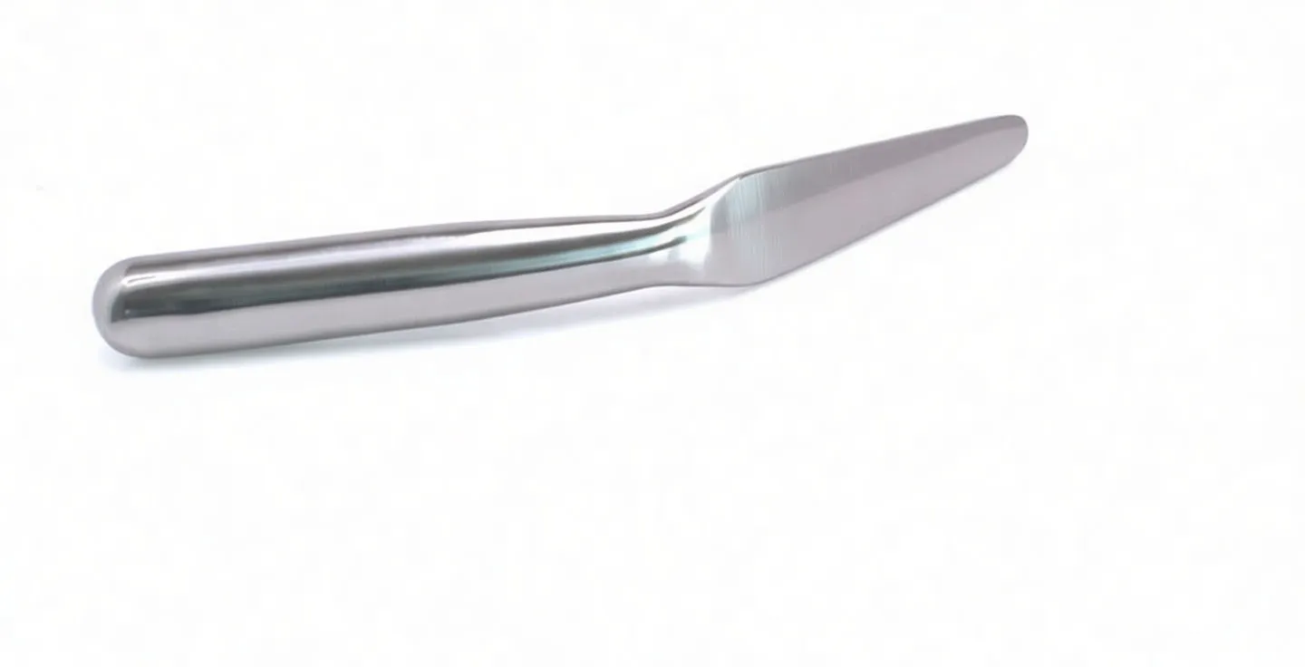 Close-up of bent tinsmith's spoon showing embossed marking on the angled shank and rounded blade tip.