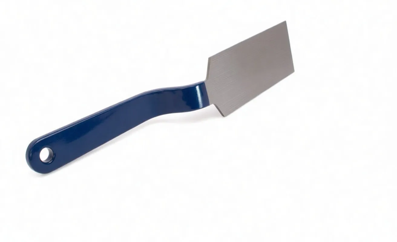 Angled view of tinsmith's spoon showing bent shank, stamped blade and blue handle with hanging hole