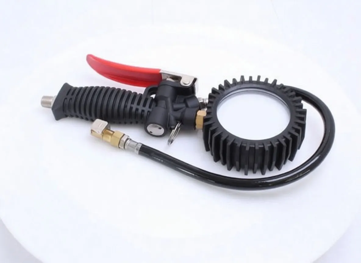 Inflator gun with gauge, hose and brass chuck on white background, showing red trigger and ribbed handle