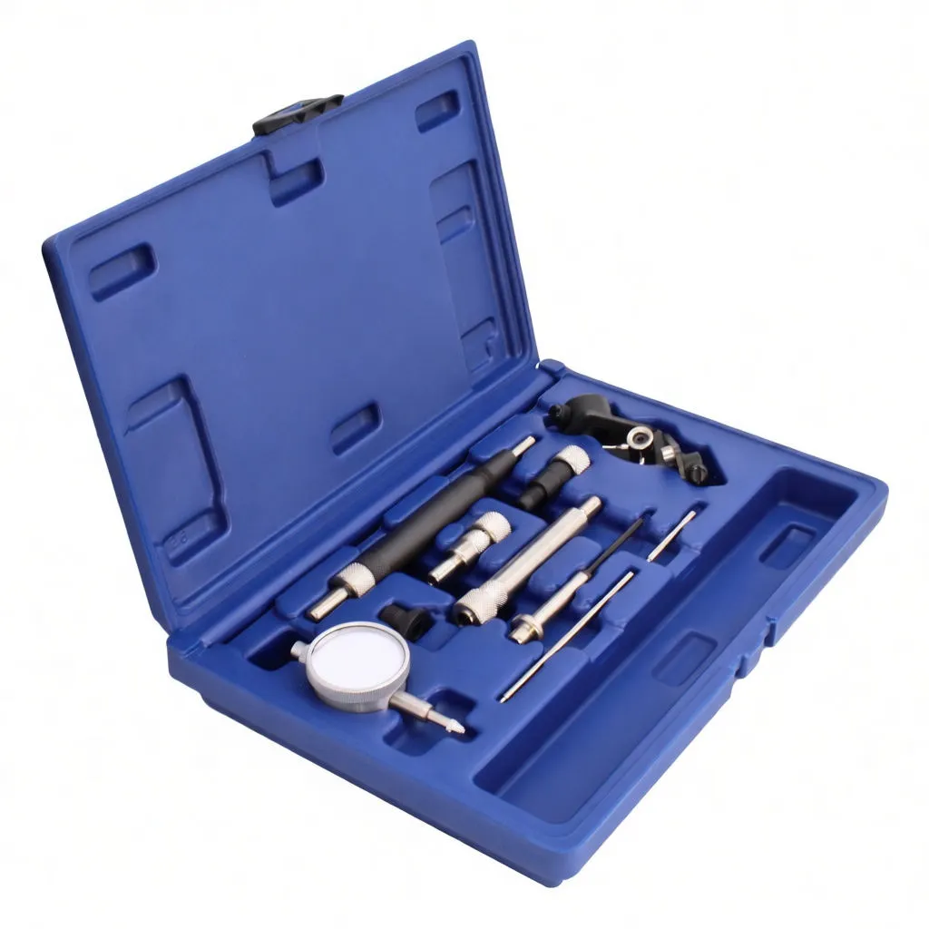 Angled shot of open blue tool case with dial gauge, metal adapters, black extensions and an adjustable clamp; yellow label inside lid.