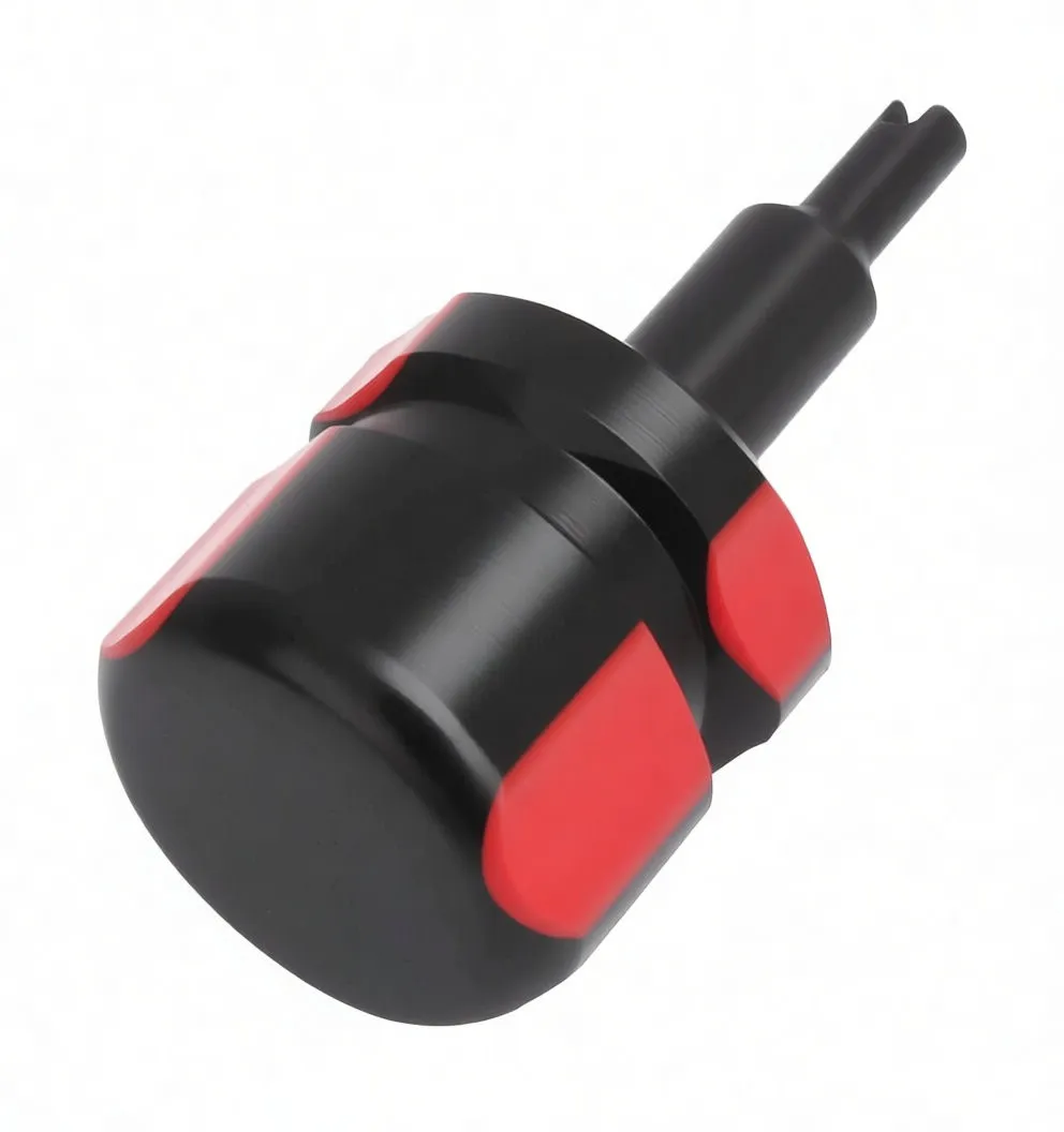 Side view of valve core remover showing black shaft with white marking, clear handle with red grips and knurled metal collar.