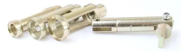 Angled detail of several slotted compressor adapters and a pivot tube with securing bolt, gold plated, on a white background.