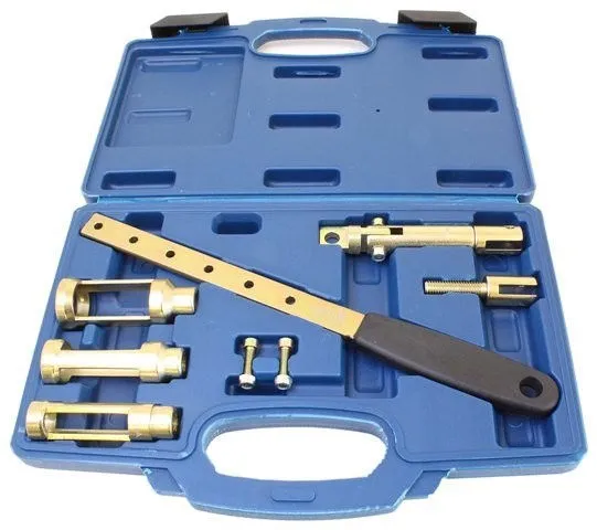 Overhead view of valve spring compressor set in blue molded case showing handle, perforated bar, three metal cups, pivot tube and small bolts.