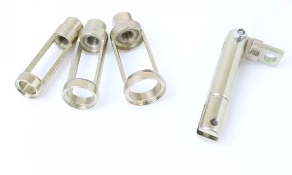 Close-up of three slotted cylindrical adapters and a pivot shaft for a valve spring compressor, all gold/zinc plated, on white background.