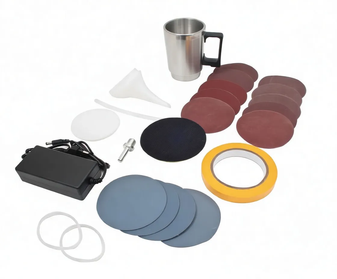 Close-up of sanding discs, velcro pad, adapter and funnel alongside mug and bottle