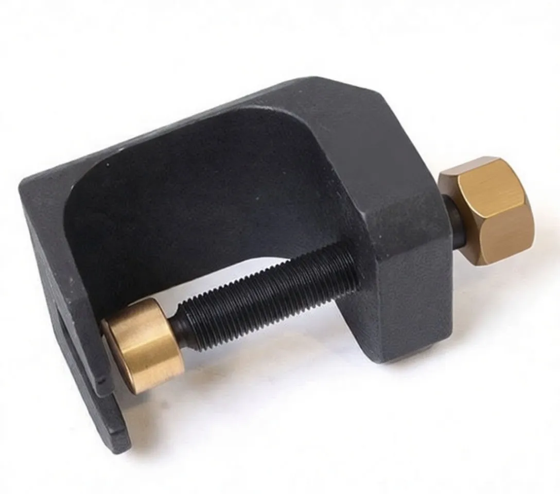 Side/top view of a black cast metal windshield wiper puller showing threaded screw, hex head and brass collar inside clamp cavity