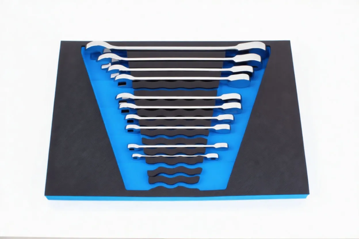 Top-down image of a blue foam tool tray with black textured overlay holding a graduated set of chrome combination wrenches and two small socket accessories, ASTA logo visible.